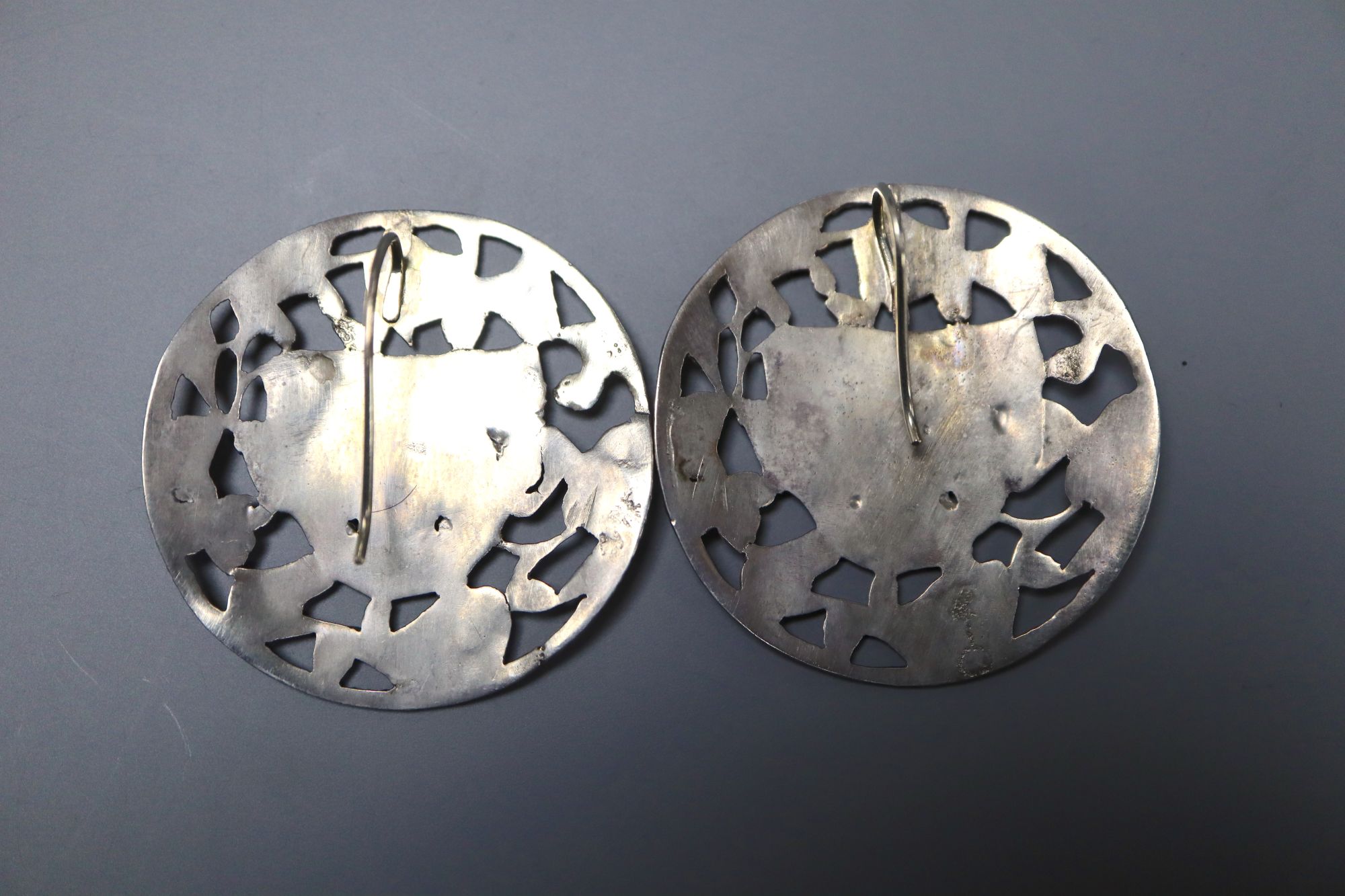 A pair of continental pierced white metal foliate and mask concave circular earrings, 38mm, gross 14.5 grams.
